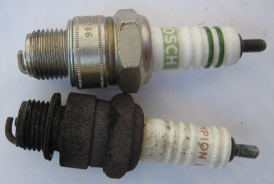 New and old spark plugs